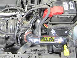 AEM Cold Air Intake 21-731C and 21-731P for the 2014 Ford Fiesta 1.6-liter non-turbo relocates the air filter outside of the engine compartment for cool, fresh, dense air