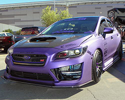 2015 and 2016 Subaru WRX STi shown here in a special purple vinyl wrap attended the 2014 SEMA Show