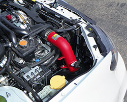 An AEM cold air intake, such as the AEM CAI for 2008-2014 Subaru WRX STi models, relocates the air filter with the goal of keeping inlet air temperature (IAT) at or near ambient air temps