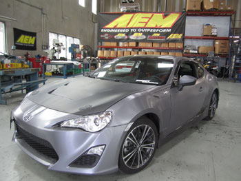 2013 Scion FRS with custom RS style carbon fiber bonnet at AEM for fit check 41-1408.