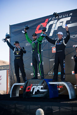 Ryan Tuerck and Tanner Foust hoisting their trophies on the podium in Sonoma.