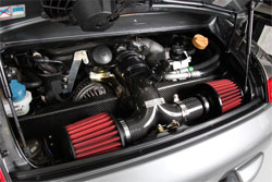 Philip Klotz clamped two AEM performance universal air filters to the end of his custom Porsche 996 GT3 air intake.